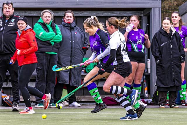 Rosie Hogarth looks to press forward for the home side, with supporters and players looking on from the sidelines. Photo by Brian Murfield