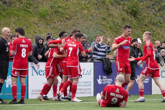 The Seadogs celebrate their late winner against Buxton, scored by sub Harry Green, right. PHOTOS BY BEN HERBERT