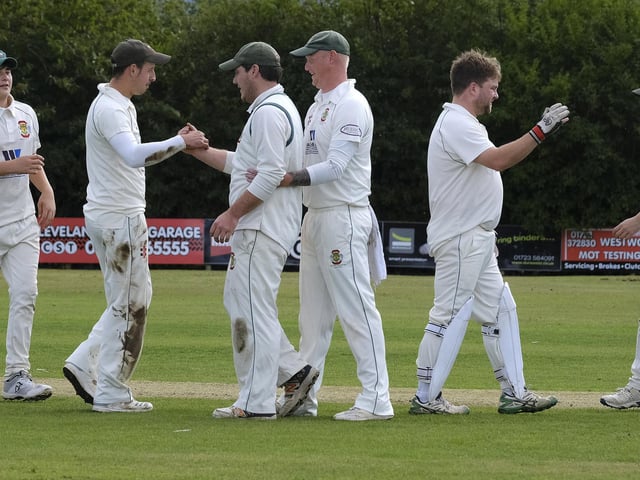 The visitors Flixton 2nds celebrate claiming a Seamer wicket