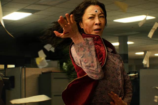 Michelle Yeoh stars as a Chinese-American woman being audited by the IRS who discovers that she must connect with parallel universe versions of herself in Everything Everywhere All at Once
