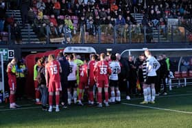 Darlington and Scarborough Athletic players leave the field along with the match officials. Match report: p62  PHOTO BY RICHARD PONTER