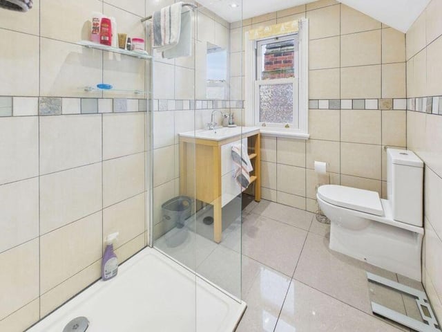 A modern walk-in shower within one of the bathrooms.
