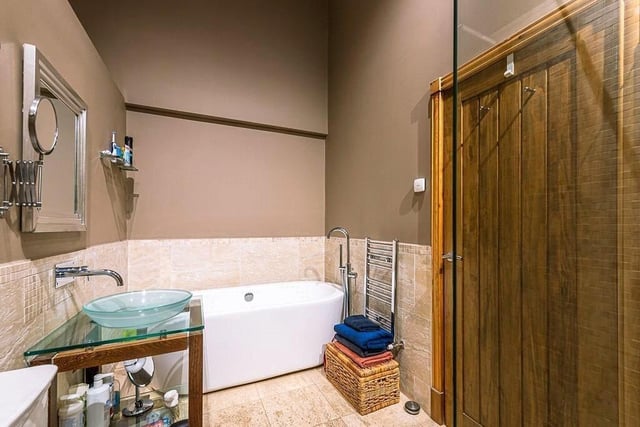A free standing bath features within this contemporary style bathroom.