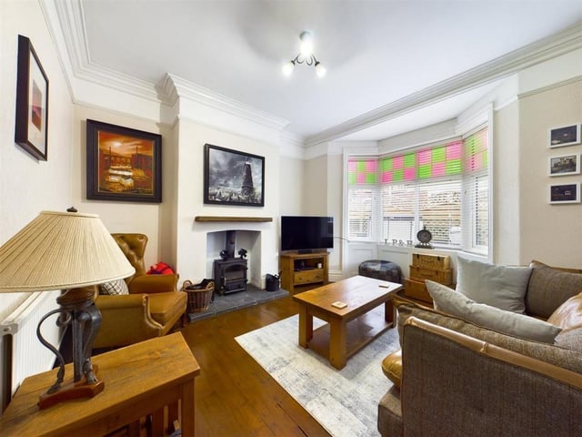 The lounge is another light and lovely room with a central fireplace and stove.