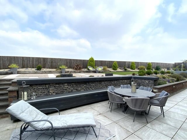 The stunning landscaped garden has terraces and water features.