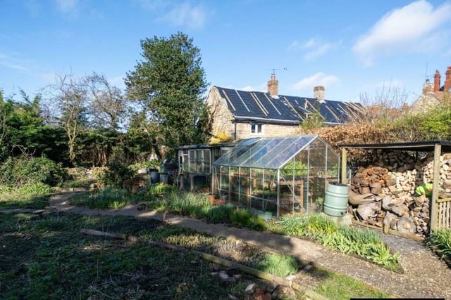 Vegetable and flower plots with greenhouses are among the facilities that lie behind the cottage.