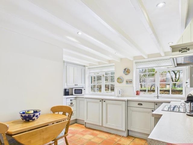 The country style kitchen has dining space.