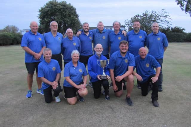 The triumphant North Cliff A squad show off their champions' trophy in August.