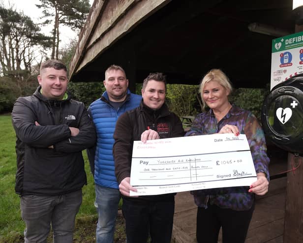 Cheque presentation at The Hayburn Wyke and new defibrillator installed - Mark Shaw and Darren Hainsworth of All Points Electrical with Keiron Hardwick representing the Air Ambulance and landlady Sharon Simpson. Pic: Richard Ponter