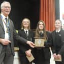 Youth Speaks winning team, Bella & the Brains, from Caedmon College, receive their trophy from organiser and Rotary President Mike Stones.