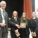 Youth Speaks winning team, Bella & the Brains, from Caedmon College, receive their trophy from organiser and Rotary President Mike Stones.
