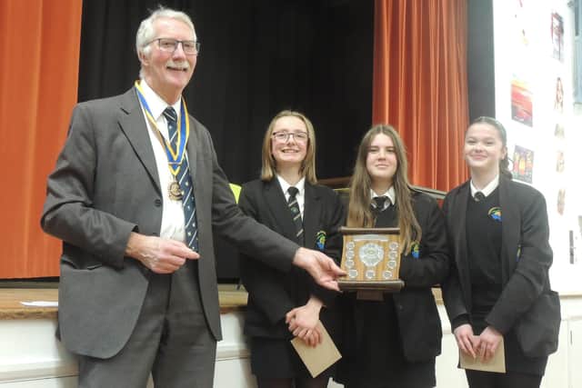 Youth Speaks winning team, Bella & the Brains, from Caedmon College, receive their trophy from organiser and Rotary President Mike Stones.