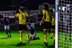 Coleby Shepherd is brought down for the late Whitby Town penalty.