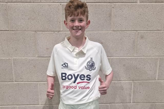 Junior Scarborough CC player Alfred Denton shows off his Boyes-sponsored team shirt.