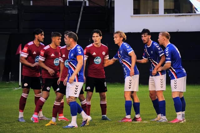 The two sets of players wait for a setpiece. Photo by Owen Cox