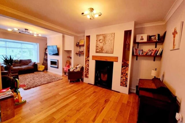 This spacious lounge has a feature fireplace and a bay window.