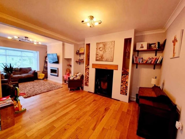This spacious lounge has a feature fireplace and a bay window.