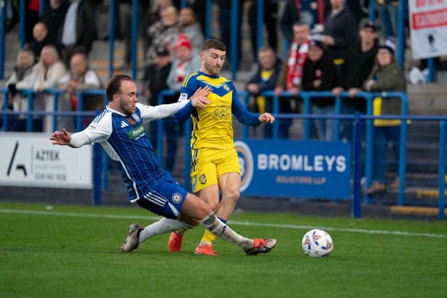 Boro's Alex Brown dodges a tackle from Curzon Ashton. Photo by Wandering Photography