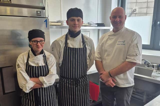 East Riding College students Sarah Friberg and Lewis Gurney alongside Anthony Gascoigne, Hospitality Programme leader.