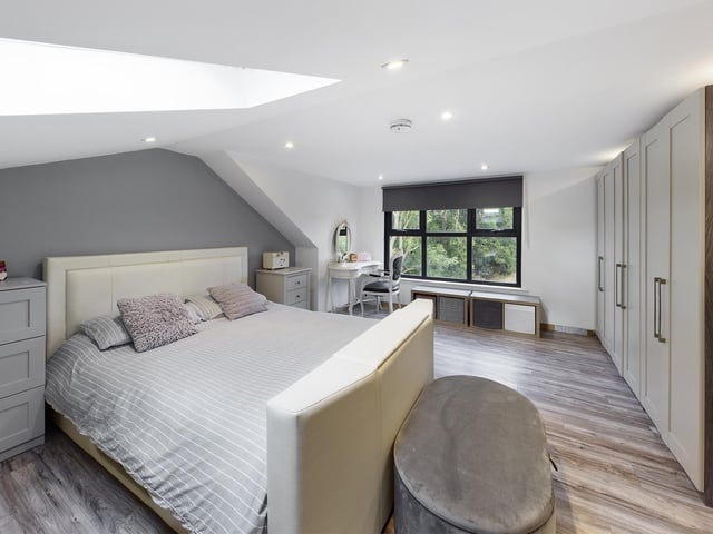 A sizeable double bedroom with wardrobes.