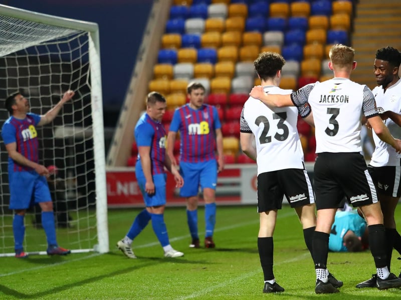 Sub Billy Leach is congratulated by teammates Ash Jackson and Kieran Weledji