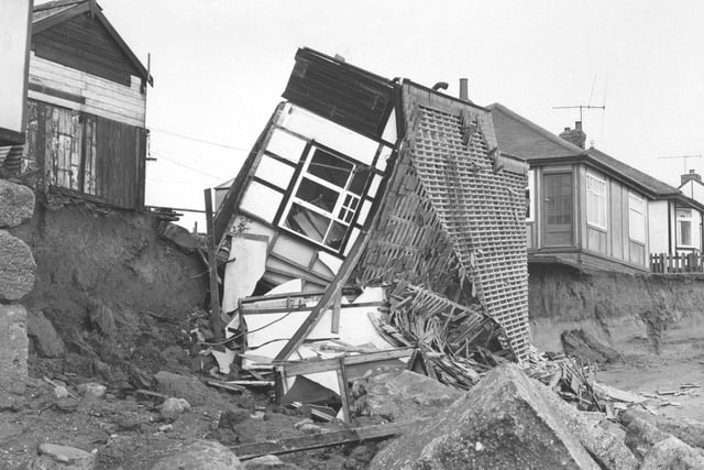 Houses falling into the sea, believed to be near Bridlington (year unknown).
