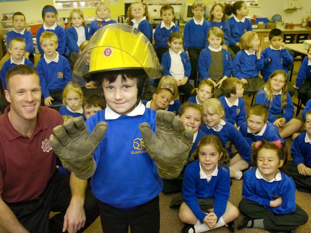 The Fire Brigade paid a visit to Gladstone Road Infant School and gave Tristan Mustoe a chance to don some real firemans gear. He is pictured with Firefighter Terence Gregg and the rest of the class.  074459