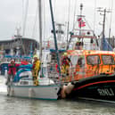 A yacht safely arrives back in Bridlington harbour with the Bridlington all-weather lifeboat.