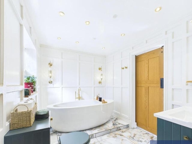 The luxury bathroom has both freestanding bath and a separate walk-in shower unit.