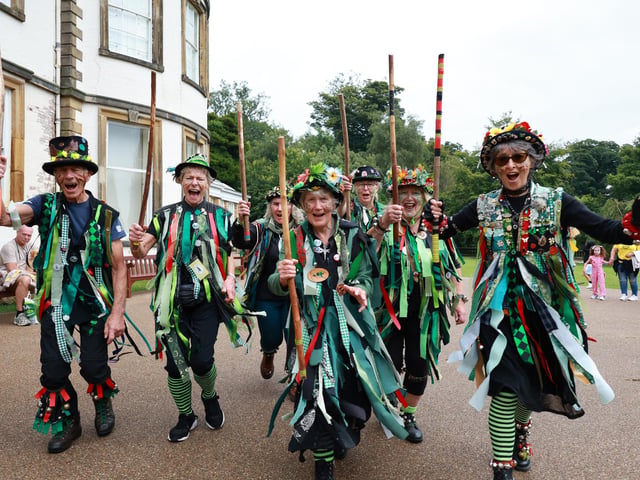 Morris Dancers performed in front of the old historic house.