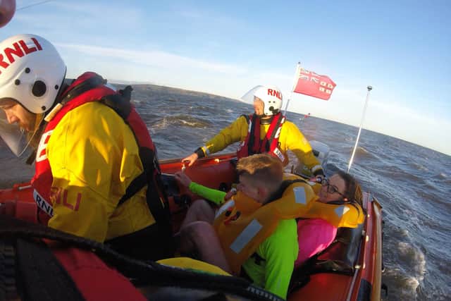 The rowers are brought to safety by the RNLI crew.