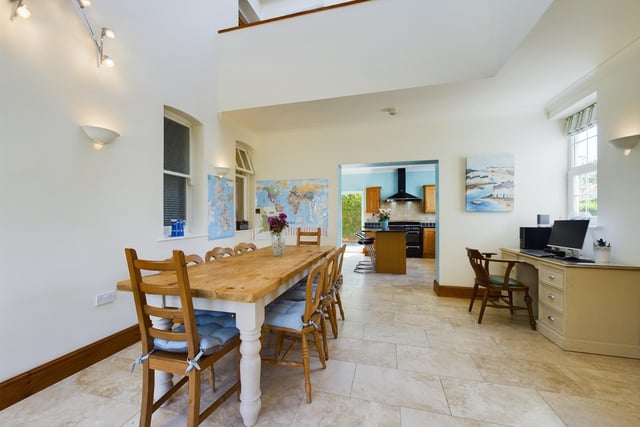 A bright and spacious dining area links to the kitchen through an archway.