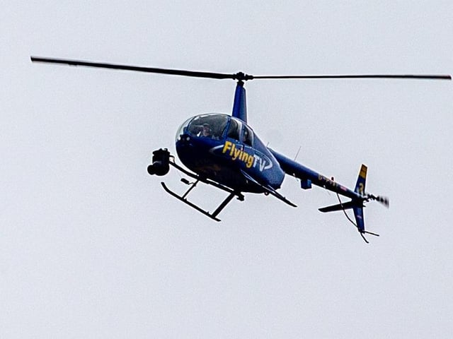 Helicopter with cameramen inside covering the big event live on TV.