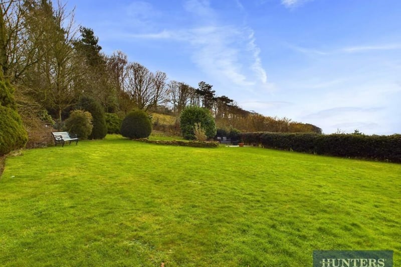 The property has a large lawned garden and views over open fields.