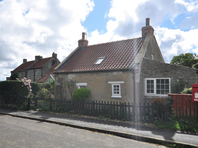 Viewing the centuries old cottage from the road.