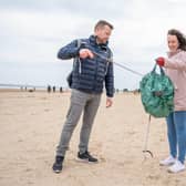 Matt Cameron and Sarah Drakes picking up litter on Bridlington beach. Credit: Richard Walker/PA Wire