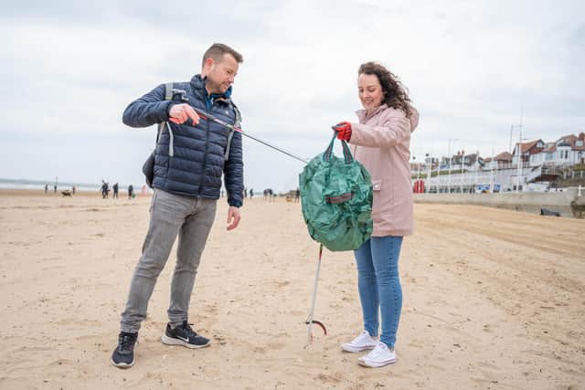 Matt Cameron and Sarah Drakes picking up litter on Bridlington beach. Credit: Richard Walker/PA Wire