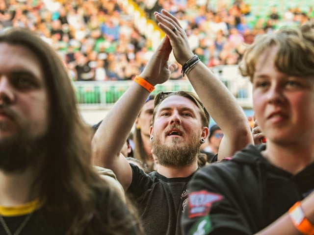 Clapping along to the beat.