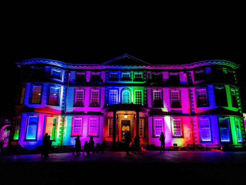 The historic house lit up in a colourful display.