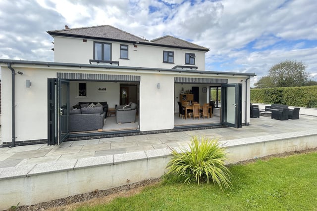 Sets of folding doors open the kitchen and diner to an outdoor patio - ideal for entertaining.