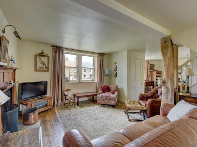 A working open fire is the focal point of the lounge, with cast iron fireplace and wood surround.