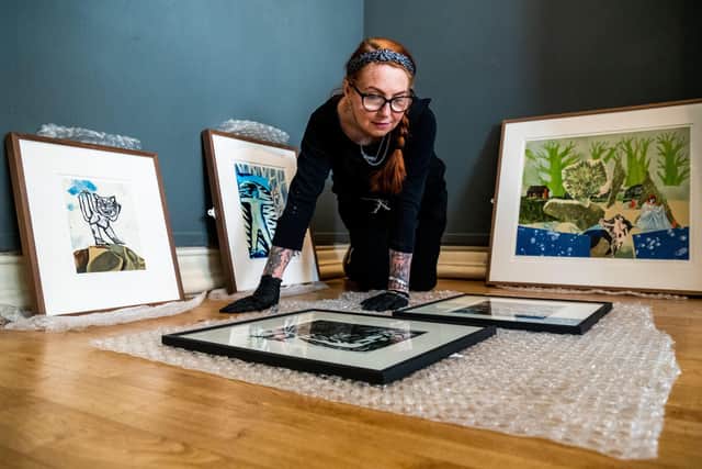 Cassie Taal, collections assistant curator, arranging artwork for Christopher's exhibition at Scarborough Art Gallery