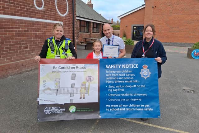 From left, Police Community Support Officer at North Yorkshire Police, Natalie Blacker, Filey Junior School pupil Freya Hammerton, who is the winner of the banner competition, headteacher Michael Taylor, and community safety officer at North Yorkshire Council, Karen Nattress.