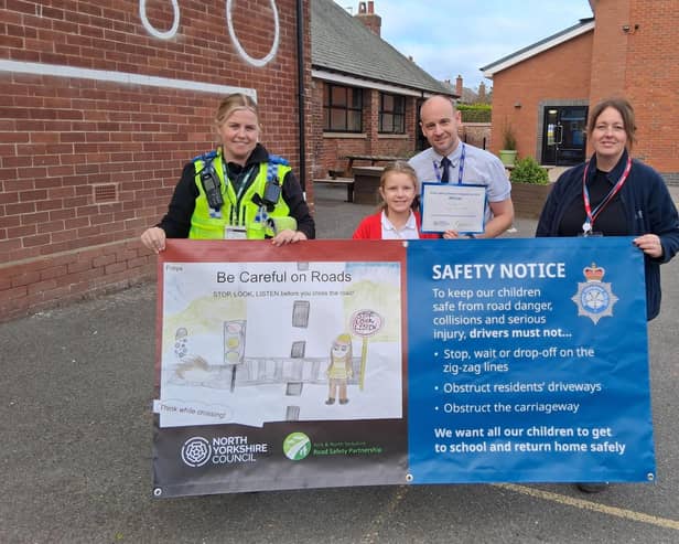 From left, Police Community Support Officer at North Yorkshire Police, Natalie Blacker, Filey Junior School pupil Freya Hammerton, who is the winner of the banner competition, headteacher Michael Taylor, and community safety officer at North Yorkshire Council, Karen Nattress.