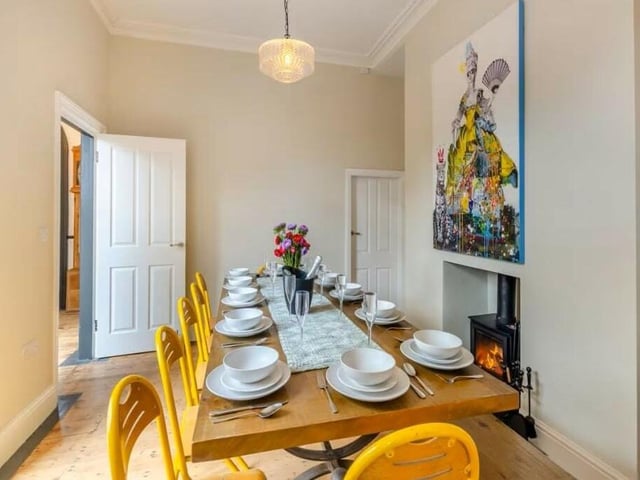The dining room has double doors to the yard garden, as well as access to the kitchen.