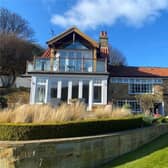 The property formed from three separate cottages has landscaped gardens, with sea views.