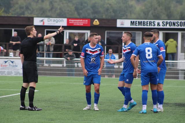 The referee talks to several Whitby Town players at Ilkeston Town. PHOTO BY OWEN COX