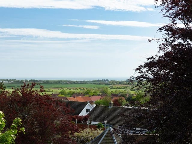 Looking out from the house over countryside to the sea in the distance.