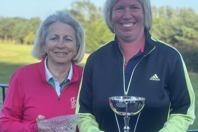 Hannah Bailey, right, and Kate Owen show off their silverware after winning their respective South Cliff Golf Club ladies competitions