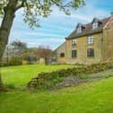 An exterior view of the attractive farmhouse property.